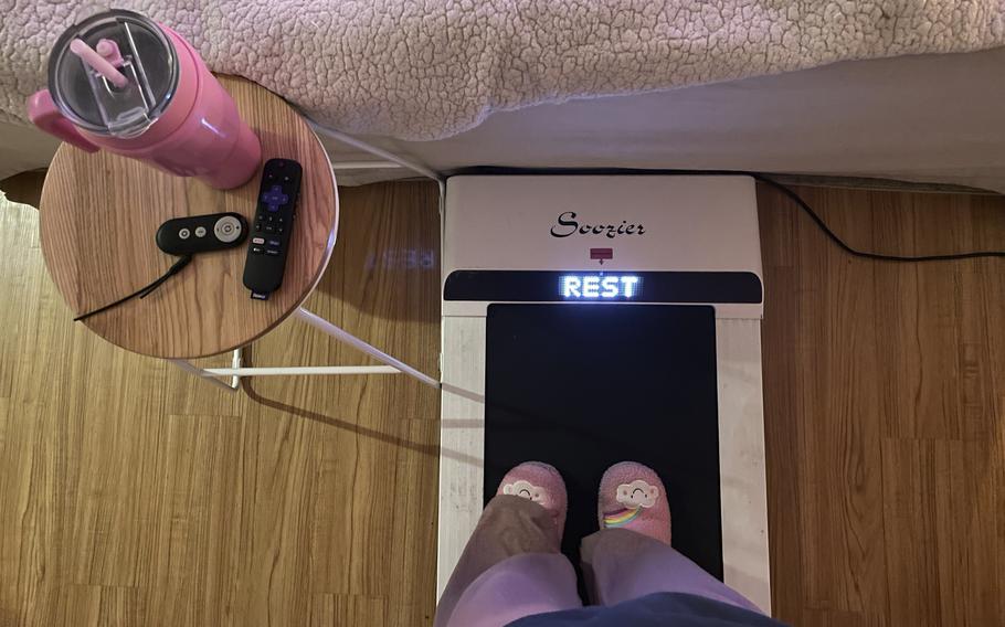 Hope Zuckerbrow, founder of the cozy cardio wellness movement, shows her workout setup, including a walking pad, smoothie and remote control for watching television. 