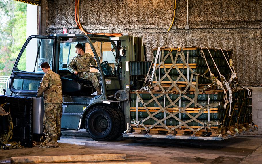 U.S. Air Force personnel in Dover, Del., move pallets of explosive charges for 155mm artillery ammunition bound for Ukraine in October 2022.