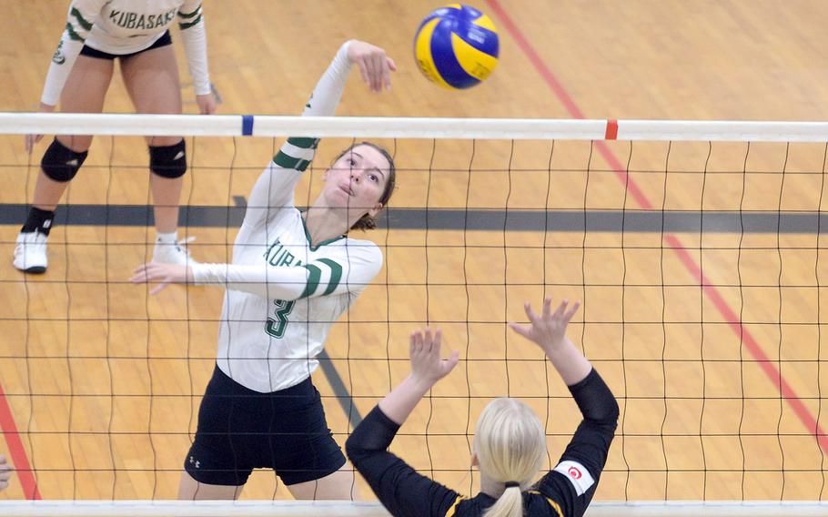 Kubasaki's Adria Lockhard spikes against Kadena's Addison Leifing during Tuesday's Okinawa girls volleyball match. The Dragons won in four sets.