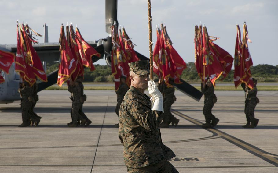 The III Marine Expeditionary Force band drum major salutes during a change-of-command ceremony at Marine Corps Air Station Futenma, Okinawa, Tuesday, Nov. 9, 2021. 