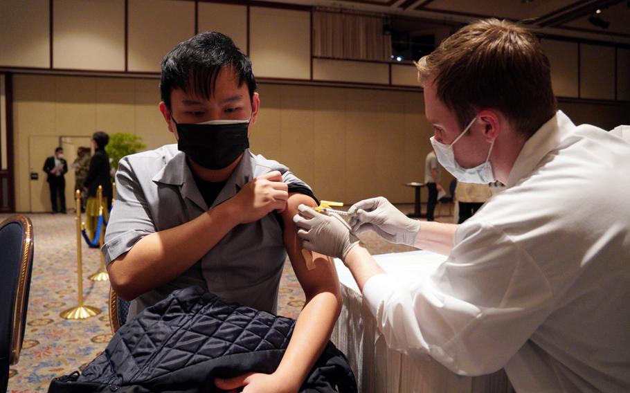 New Sanno Hotel housekeeper Shion Murayama gets a COVID-19 vaccine at the U.S. military-run facility in central Tokyo, Wednesday, Feb. 16, 2022. 