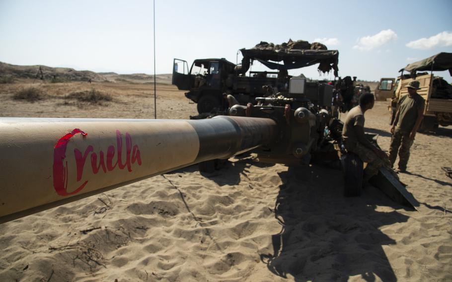 U.S. soldiers with the 7th Field Artillery Regiment stand next to a Cruella, an M777 howitzer, during Balikatan training in Laoag, Philippines, May 8, 2024.