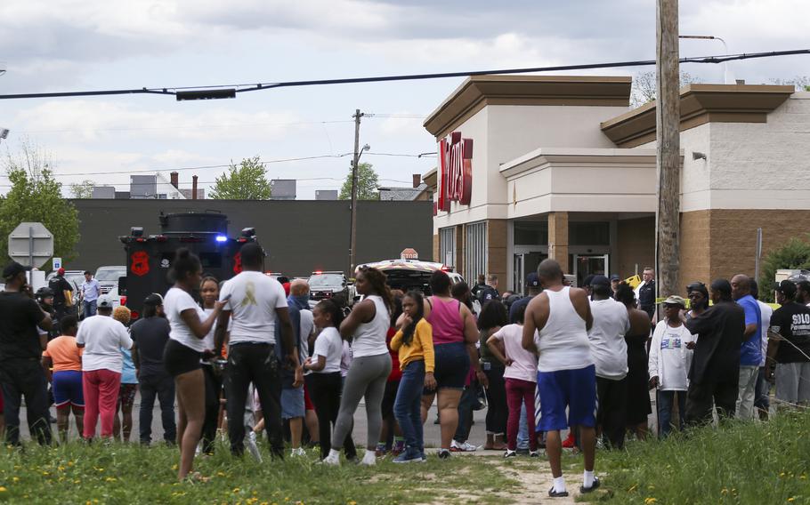 A crowd gathers as police investigate a shooting at a supermarket on Saturday, May 14, 2022, in Buffalo, N.Y.