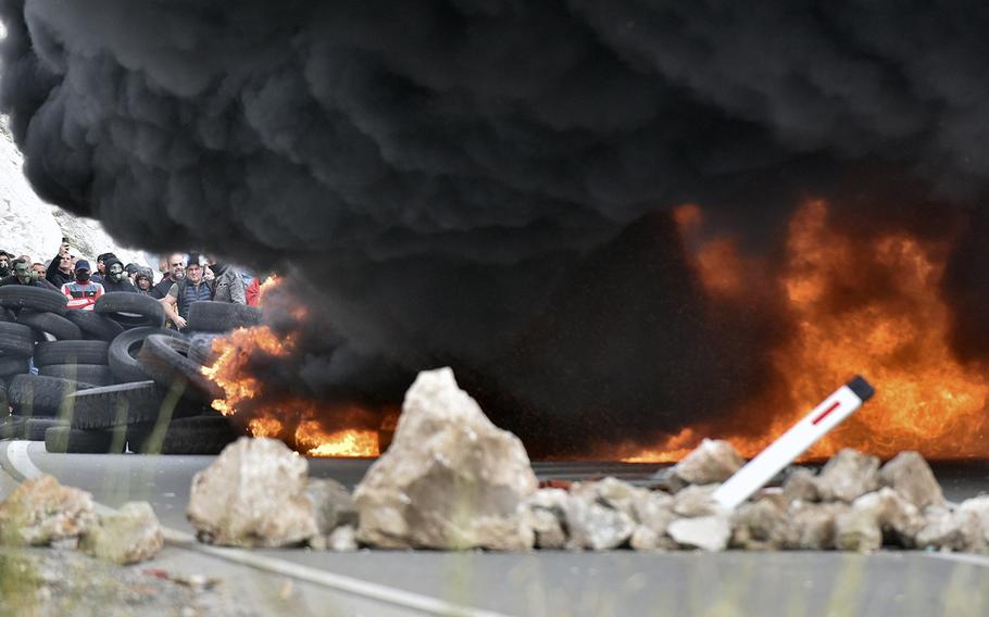 Smoke rises from burning tires which protesters set fire at one of the blockades near Cetinje, Montenegro, Sunday, Sept. 5, 2021.