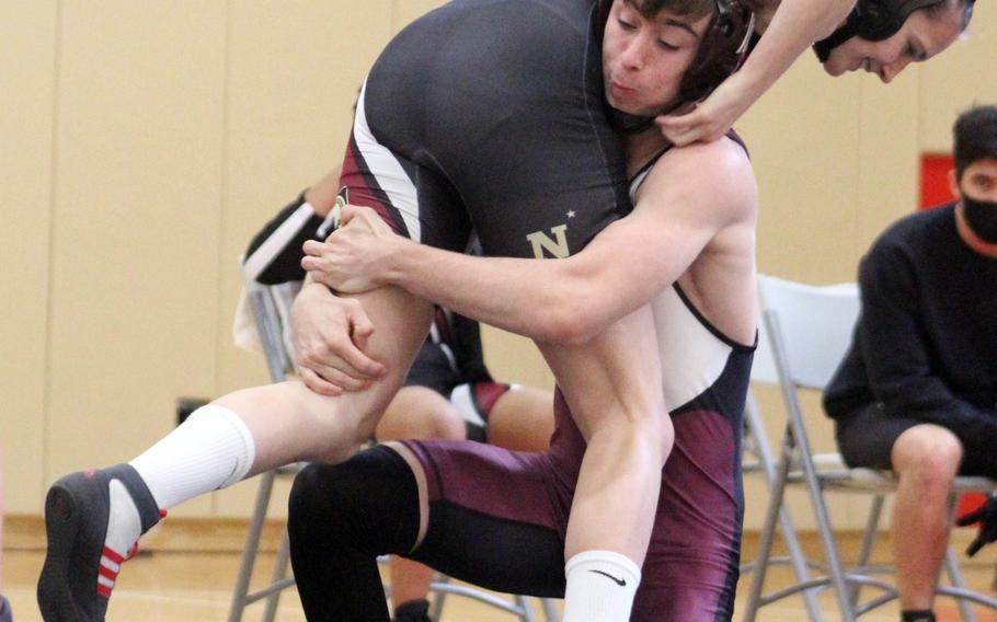 E.J. King’s Ryan Fenwick lifts Zama‘s Lumina Fennessey at 135 pounds during Saturday’s DODEA-Japan wrestling tri-meet. Fenwick won by pin in 2 minutes, 1 second and the Cobras won the dual 49-5. 