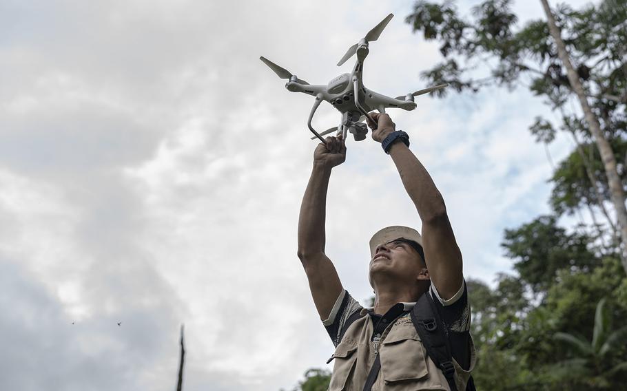 A monitor launches a drone to survey the illegal coca crop in Ucayali, Peru.