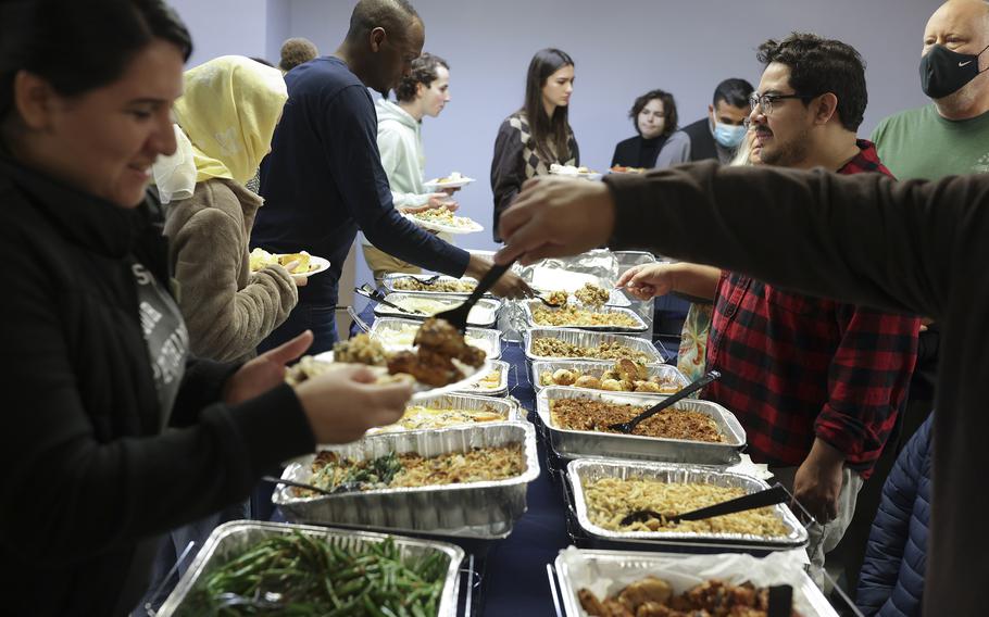 Refugees, volunteers and members of the community gather for a Thanksgiving dinner in Arlington hosted by Ethiopian Community Development Council.