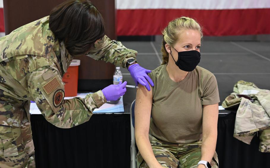 Master Sgt. Tiffany Sneeze, from the 165th Airlift Wing, administers the COVID-19 vaccination to an airman on June 8, 2021 on Dobbins Air Force Base, Ga. Airmen who have not been fully vaccinated against the coronavirus will not be allowed to proceed to their next permanent duty station beginning Monday, according to a memo issued by the Air Force.