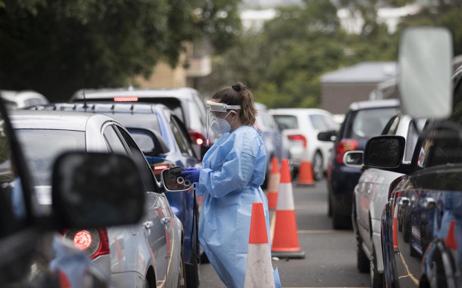 A health care worker registers a member of the public in a car at a COVID-19 testing site in Sydney on Dec. 16, 2021. 