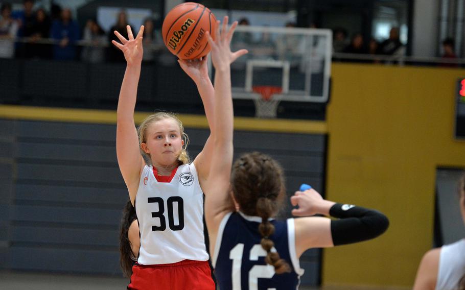 American Overseas School of Rome’s Clara Clayton shoots over Black Forest Academy’s Emma Gibson in a Division II semifinal at the DODEA-Europe basketball championships in Ramstein, Germany, Feb. 17, 2023. AOSR beat BFA 34-31 to advance to the championship game against Naples.
