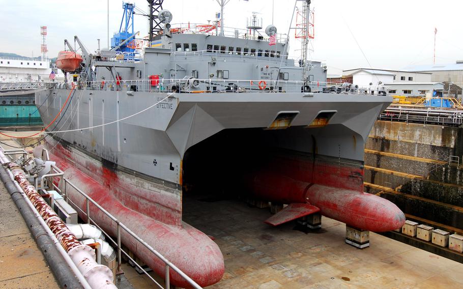 A naval ship sits in dry dock.