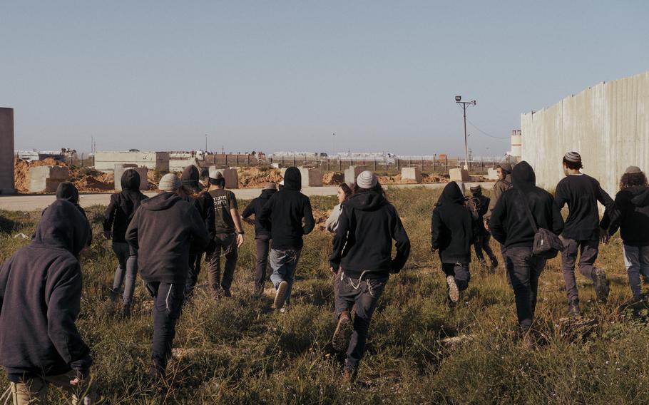 Israeli protesters run toward aid trucks waiting to cross at the Kerem Shalom crossing on Feb. 7.