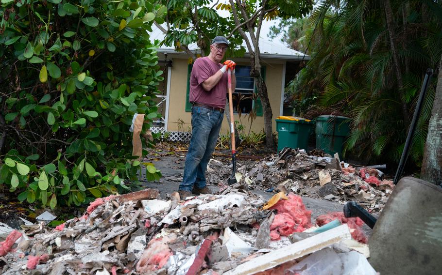 Douglas Lowe, 67, of Utah, shovels debris from his vacation home in Naples, Fla. (MUST CREDIT: Washington Post photo by Sarah L. Voisin)