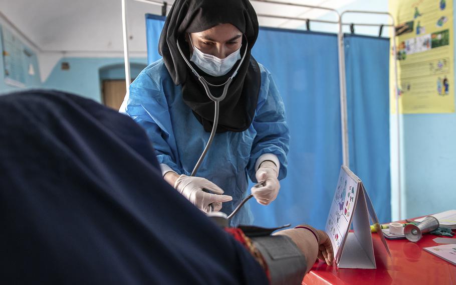 A Save the Children midwife provides Zarmina, 25, who is five months pregnant, with a pre-natal check-up in Jawzjan province in northern Afghanistan, Sunday, Oct. 2, 2022. 