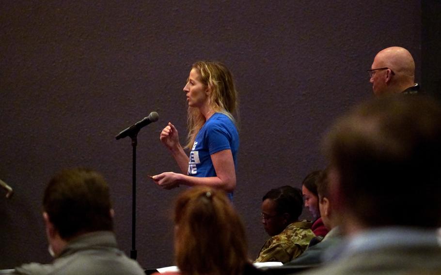 A woman asks a question about civilians' access to health care during a town hall meeting at Yokosuka Naval Base, Japan, Tuesday, Jan. 31, 2023.