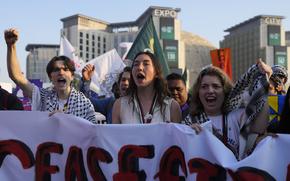 Activists demonstrate for climate justice and a ceasefire in the Israel-Hamas war at the COP28 U.N. Climate Summit, Saturday, Dec. 9, 2023, in Dubai, United Arab Emirates. (AP Photo/Rafiq Maqbool)
