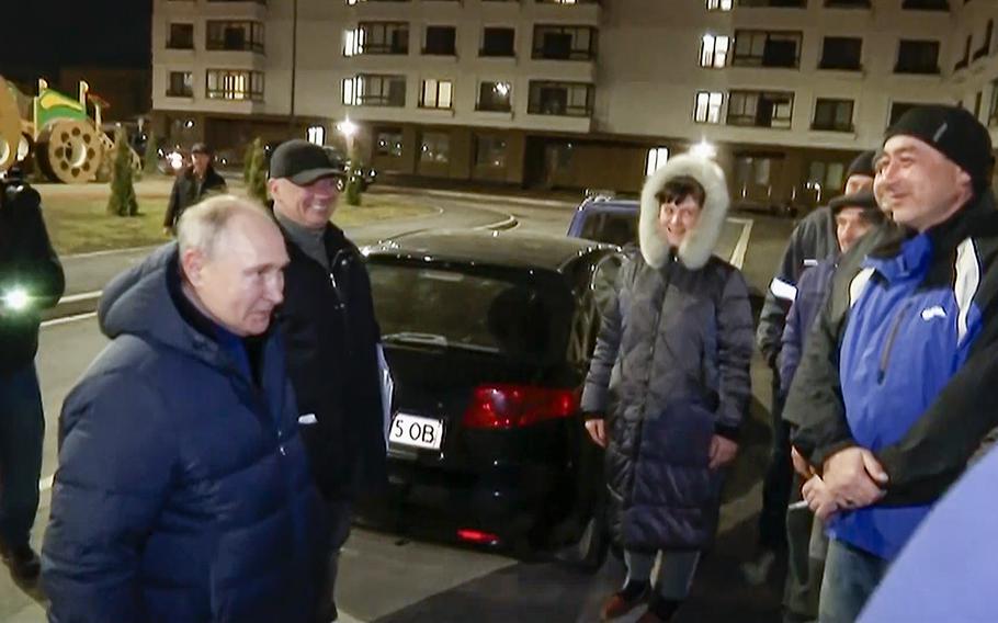 In this photo taken from video released by Russian TV Pool on Sunday, March 19, 2023, Russian President Vladimir Putin talks with local residents during his visit to Mariupol in Russian-controlled Donetsk region, Ukraine. Putin has traveled to Crimea to mark the ninth anniversary of the Black Sea peninsula’s annexation from Ukraine.