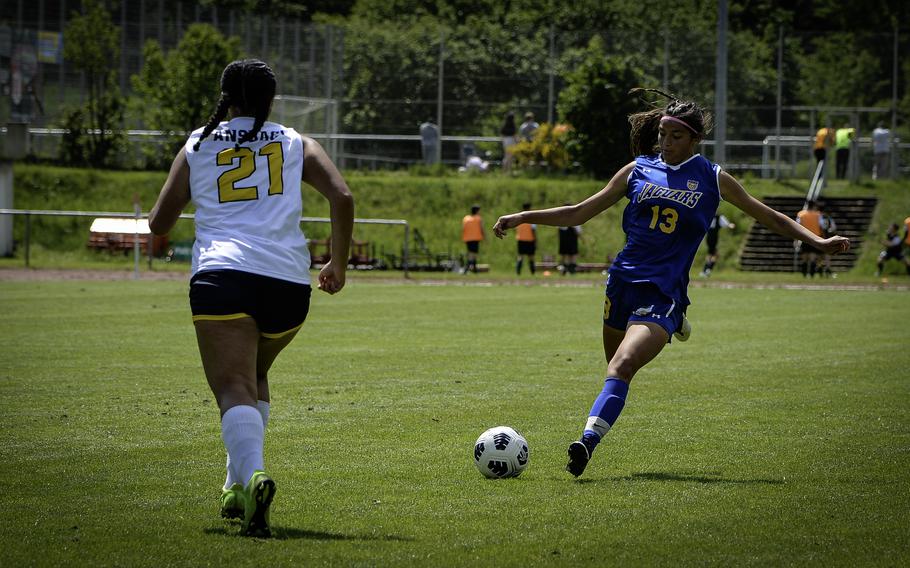 Ryleigh Denton of Sigonella takes a shot at goal outside the Ansbach penalty zone as Ansbach’s Oliolisaga "Oli" Cormier tries to intercept during the 2024 DODEA European Soccer Division III Championships in Landstuhl, Germany, on May 20, 2024.