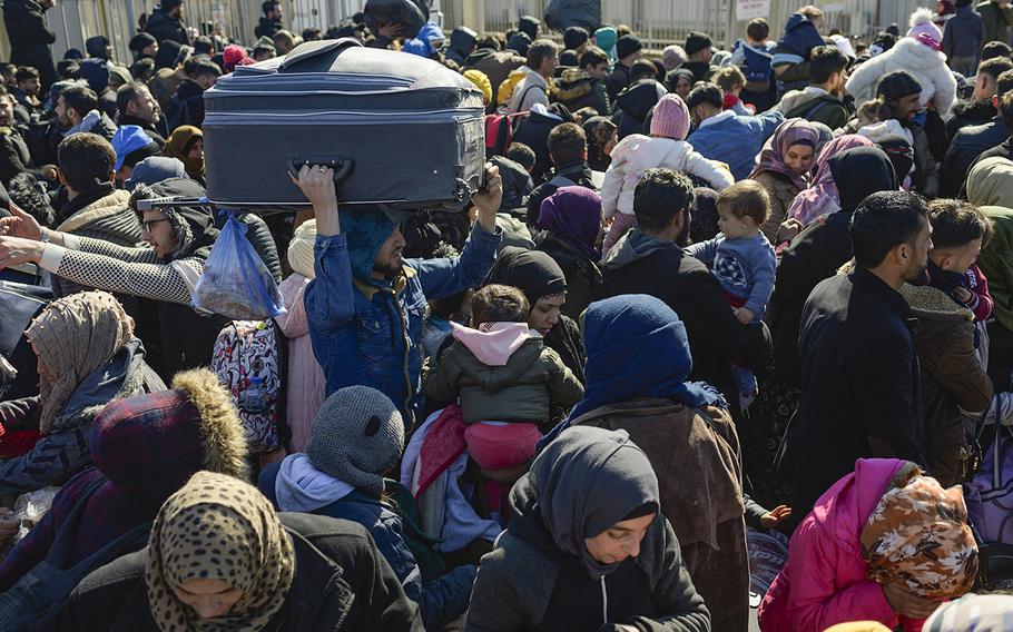 Syrian residents of Hatay city wait to cross the Turkish-Syrian border after they were affected by the 7.8-magnitude earthquake that struck the region nearly two weeks ago, at Cilvegozu border gate on Feb. 17, 2023. 