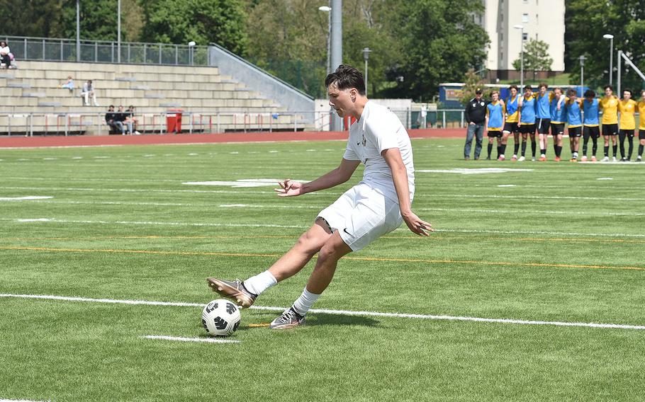 Ramstein senior Mathias Bailey kicks the winning penalty against Stuttgart in a Division I semifinal of the DODEA European soccer championships May 22, 2024, at Kaiserslautern High School in Kaiserslautern, Germany.