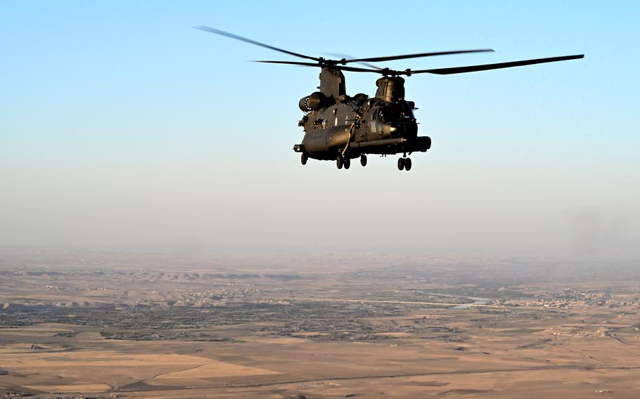 A U.S. Army MH-47G Chinook in flight in the Middle East on Oct. 10, 2022. A Chinook helicopter went down in apparently good weather and without taking hostile fire on Sunday, leaving 22 service members injured, U.S. officials said. 