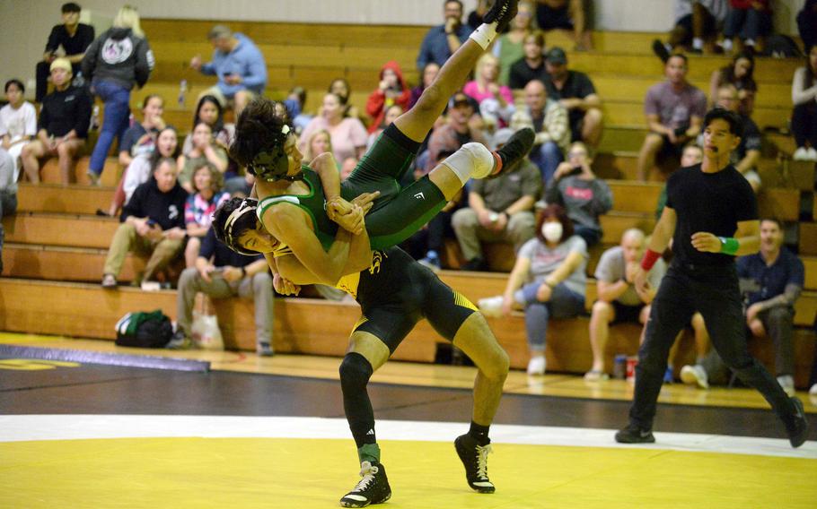 Kadena's Cedric Ferguson takes charge of Kubasaki's Jesse Fuentes at 114 pounds during Wednesday's Okinawa wrestling dual meet. Ferguson won by pin and the Panthers won the meet.