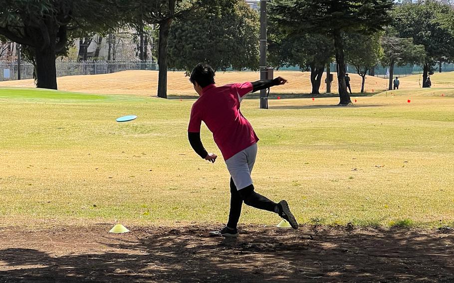 A man throwing a golf disc.