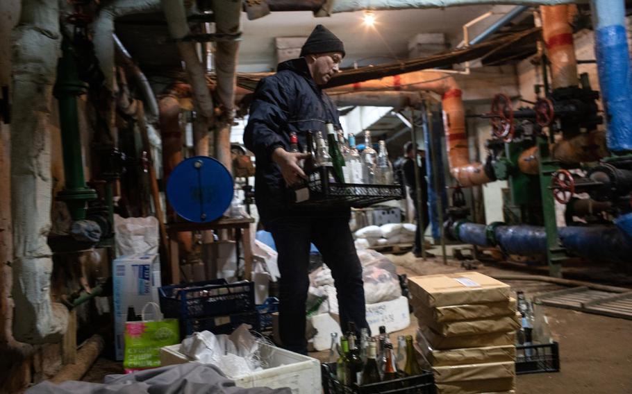 A volunteer collects empty bottles in the preparation of molotov cocktails in Kyiv, Ukraine, on Feb. 26, 2022. 