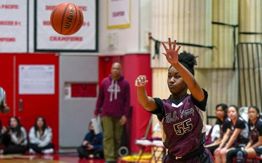 Matthew C. Perry's Kaiden Bradley sends a pass cross court against Nile C. Kinnick during Friday's DODEA-Japan girls basketball game. The Red Devils won 42-17.