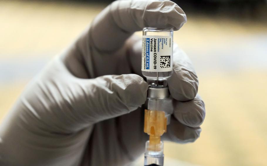 A medical worker prepares a dose of the Jannsen COVID-19 vaccine at Osan Air Base, South Korea, March 11, 2021.