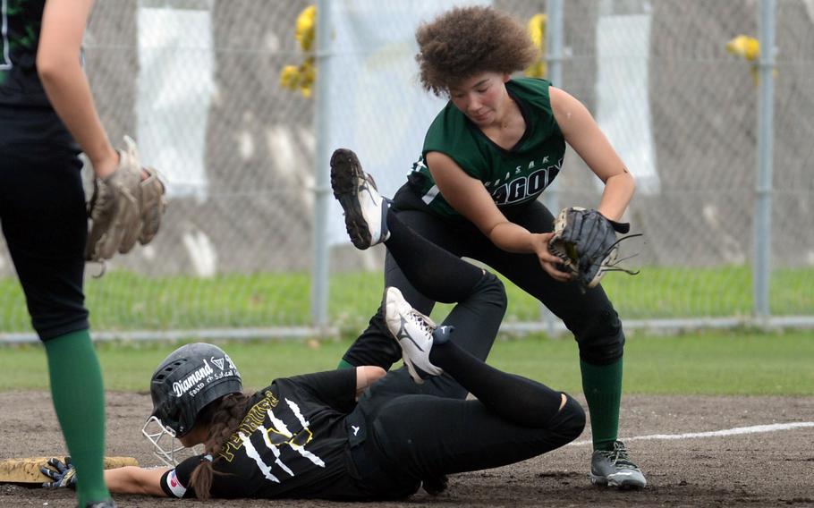 Kadena's Julia Petruff dives into third base ahead of the tag attempt by Kubasaki's Una Freeman during Tuesday's Okinawa softball regular-season finale. The Panthers won 14-1 to wrap up an unbeaten 8-0 regular season against the Dragons.