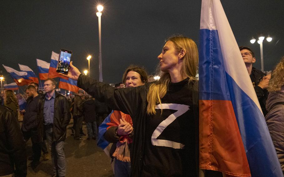 A woman wears a shirt marked with the Z insignia of Russia’s invading forces in Ukraine during a celebration on Red Square of the illegal annexation of four Ukrainian regions on Sept. 30, 2023. 