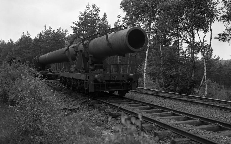 A massive Nazi Germany-produced railway gun is being disassembled in the woods near Grafenwöhr, Germany, by American forces in July 1949. The deployment of the gun by the Germans was an enormous endeavor. It took five trains with a total length of 5,423 feet to transfer the gun parts to the front. Two construction cranes and some 250 men were needed to set it up and get it fire-ready — a process that took several weeks.