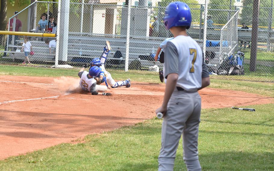 Ansbach's Jorge Ortega is tagged out at the plate by Sigonella catcher Kenji Corpusz while Ansbach's Bobby Lovallo waits on deck on Saturday, April 30, 2022 at Aviano Air Base, Italy.