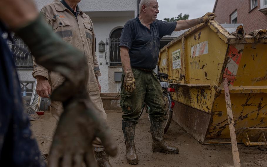 Horst Schmeing cleans the flood-damaged house of his nephew in Bad Neuenahr, Germany on July 16, 2021. 