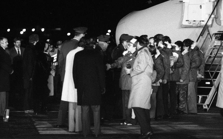 Officials greet the so-called Iran hostages as they step out of one of the two C-9 planes that ferried them from Tehran, Iran, to Rhein-Main Air Base in Germany.