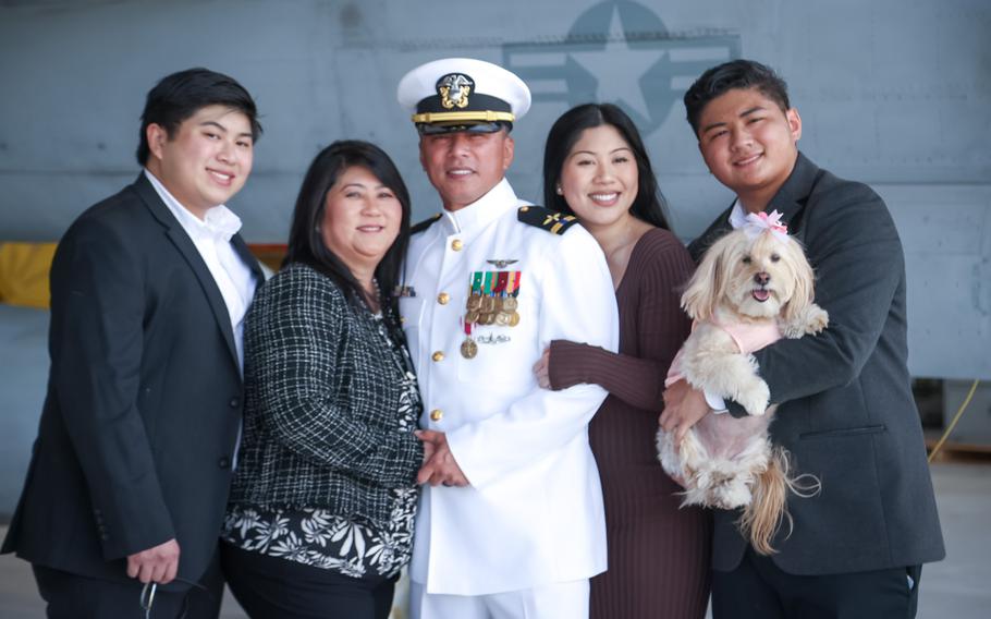 Chief Warrant Officer 4 Jules Amores retired Friday, March 25, 2022, from the Navy after 30 years of service, which began through a now-shuttered recruiting program in the Philippines. Amores is seen here with his family. From left to right is his son Jules, his wife Jennifer, Amores, his daughter Julianne, and his other son Jerrick holding CoCo the dog.