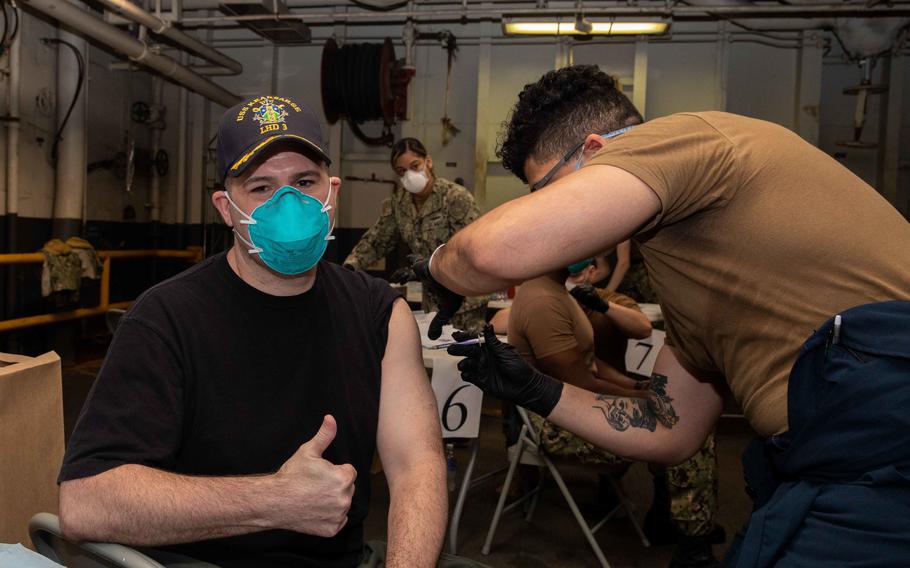 Hospital Corpsman 3rd Class Randy Jimenez administers a COVID-19 vaccine to Capt. Tom Foster, executive officer of the Wasp-class amphibious assault ship USS Kearsarge (LHD 3), on March 31, 2021. Defense Secretary Lloyd Austin is preparing to issue a mandate for all troops to receive the coronavirus vaccine after the Food and Drug Administration gave its full authorization for one of the shots.