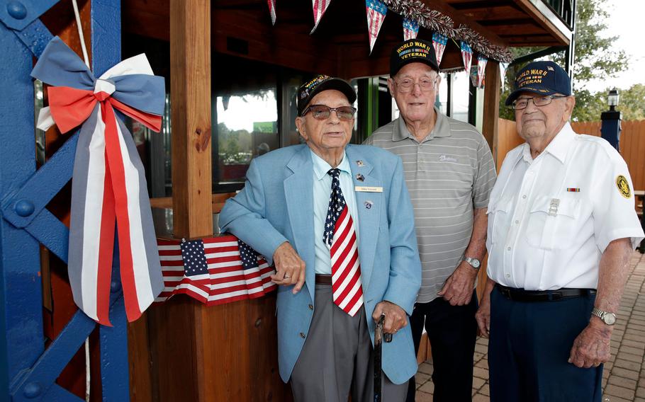 World War II veterans (left to right) Mike Visconti, Arthur Hobbs and Ronald Wollet talk about their war experiences and the impact of the Pearl Harbor attack this week at AmVets Post 2 in Edgewater, Fla. 
