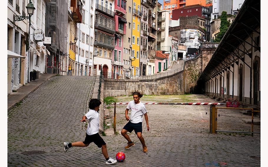 Boys play soccer near the Porto São Bento train station in an area often littered with used syringes. 