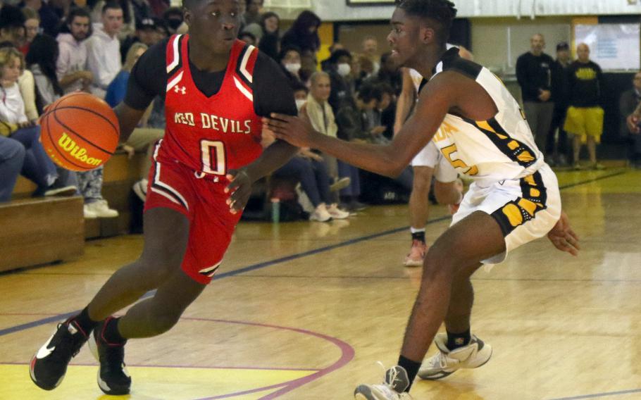 Kinnick's Luke Oriem dribbles against Kadena's Cedrick Dorelein during Tuesday's 58-47 win by the Panthers over the Red Devils.