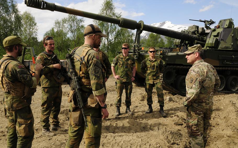 Col. Daniel Miller, 41st Field Artillery Brigade commander, meets with Norwegian artillery soldiers to observe firing with the K-9 self-propelled howitzer during Exercise Thunderbolt on June 9, 2021, in Setermoen, Norway.