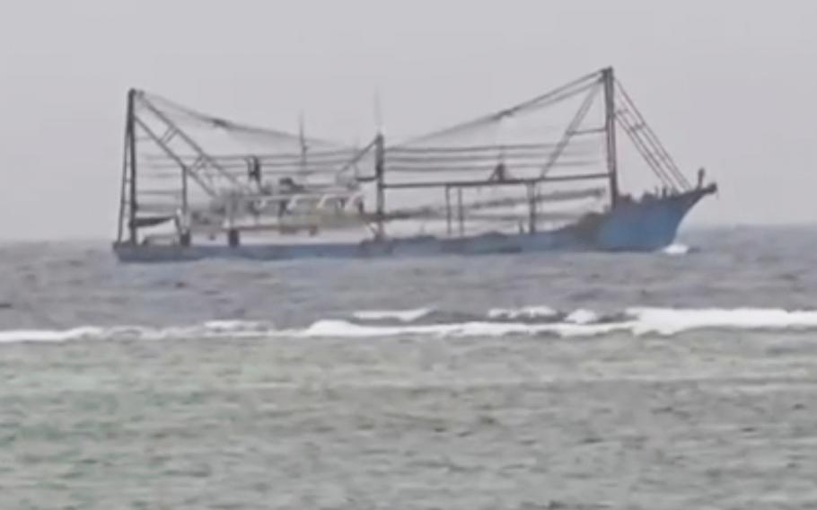 A Chinese vessel passes shallow waters off Philippines-occupied Thitu island.