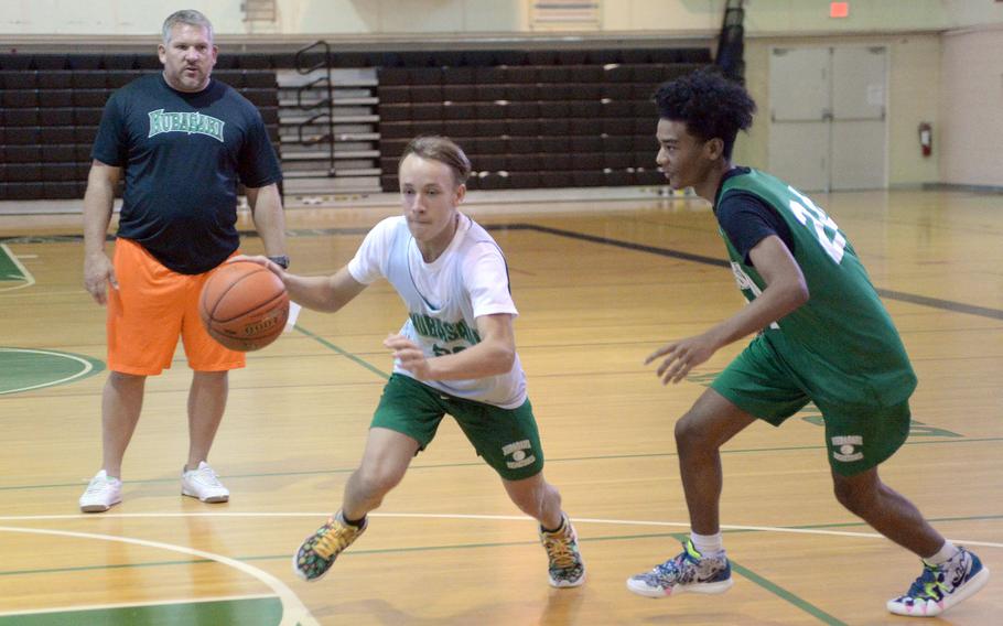 Kubasaki sophomore Dom Boursiquot and senior R.J. Graydon go through practice paces under the watchful eye of 13th-year coach Jon Fick, back after two years away from the helm.