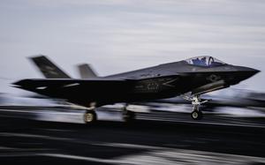 The fighter jet’s wheels hit the flight deck.