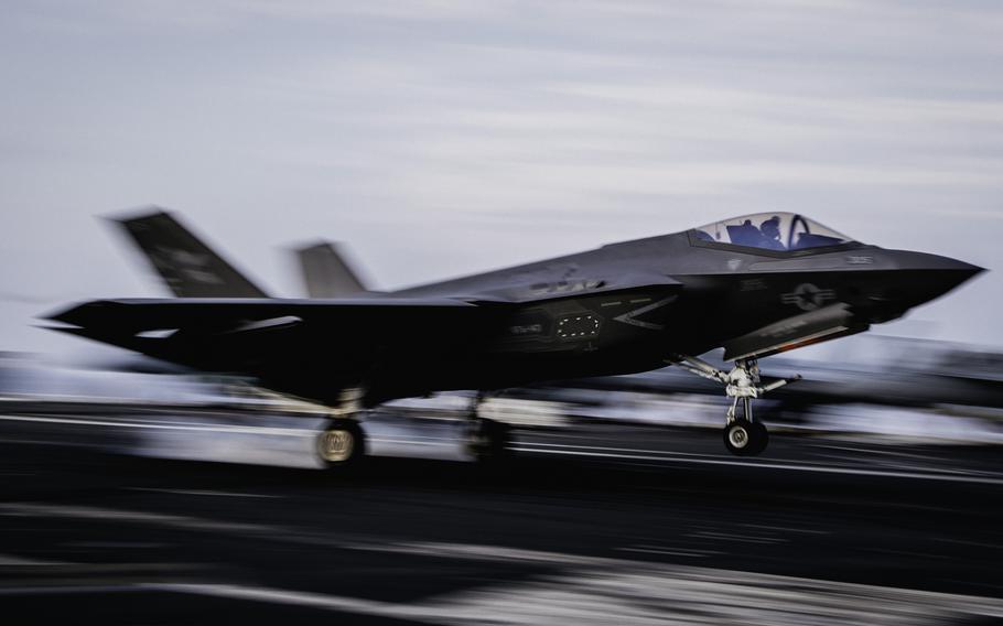 The fighter jet’s wheels hit the flight deck.