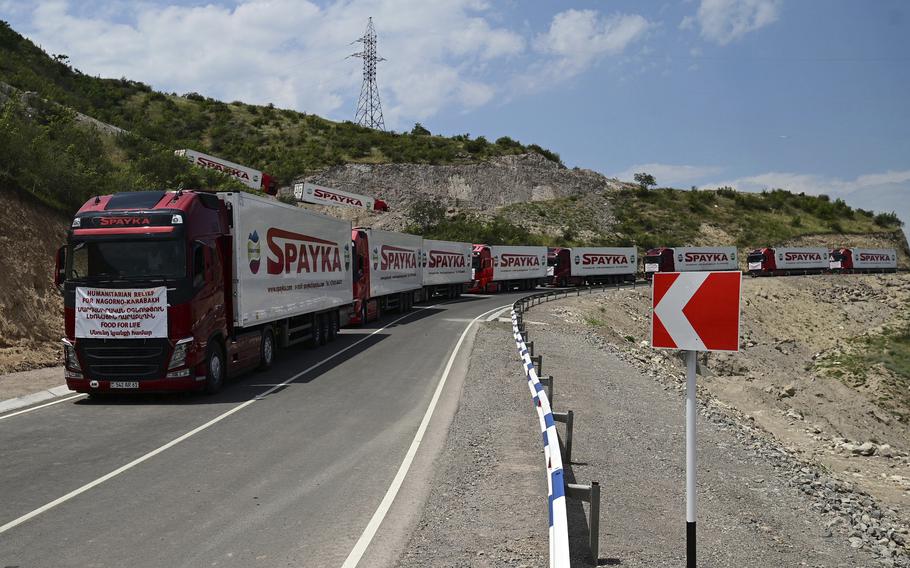 Trucks with humanitarian aid for Artsakh parked in a road towards the separatist region of Nagorno-Karabakh, in Armenia, Friday, July 28, 2023.