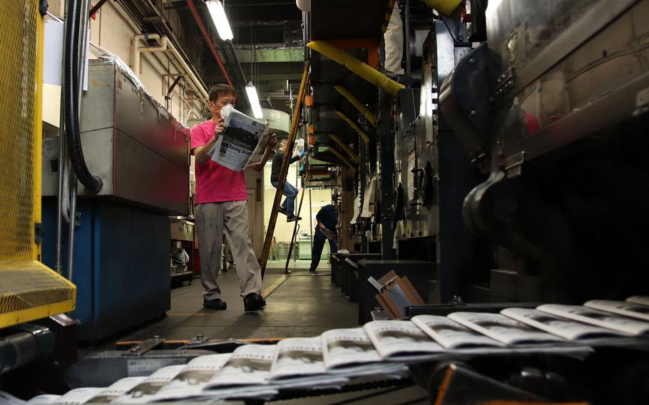 Copies of the Stars and Stripes newspaper roll off the press at Akasaka Press Center in central Tokyo, April 8, 2020. 