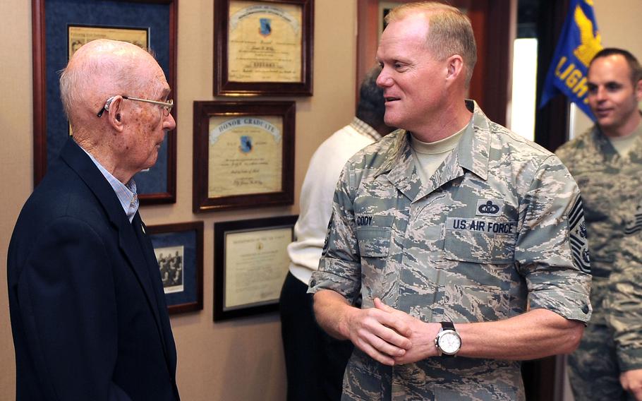 Retired 6th Chief Master Sergeant of the Air Force James McCoy speaks with the 17th CMSAF, James Cody, at the James M. McCoy Airman Leadership School March 12, 2015 at Offutt Air Force Base, Neb. 