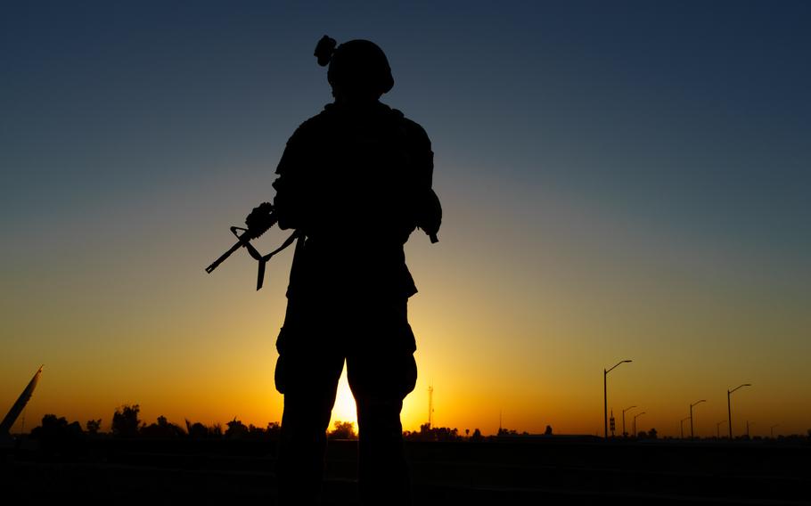 A service member overlooks the sunset during pre-combat checks and inspections in Iraq on Aug. 3, 2020. U.S. forces are deployed in support of Operation Inherent Resolve working with partner forces to defeat the Islamic State in designated areas of Iraq and Syria while establishing conditions for operations to increase regional stability. 